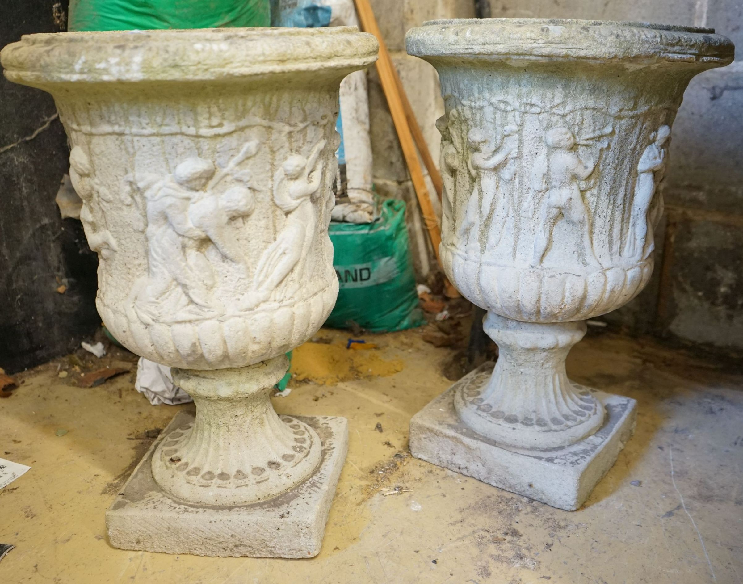 A pair of reconstituted stone campana garden urns, height 52cm